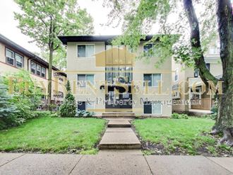 front view of a house with trees and grass