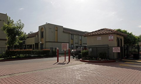 A building with a red tile roof and a sign on it.