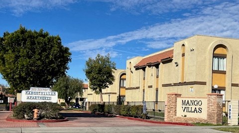 Mango Villas Apartments is a beige building with a red roof.