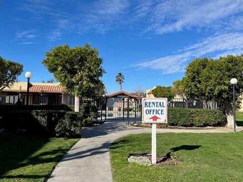 A sign in front of a building that says Rental Office.