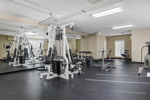 a gym with weights and other equipment in it