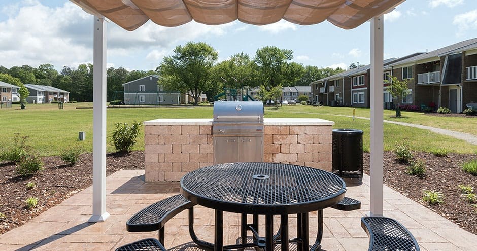 outdoor grilling area with grill station and picnic table