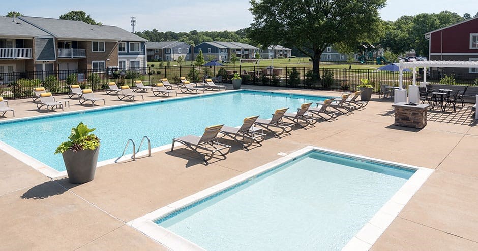 outdoor swimming pool and jacuzzi with lounge chairs