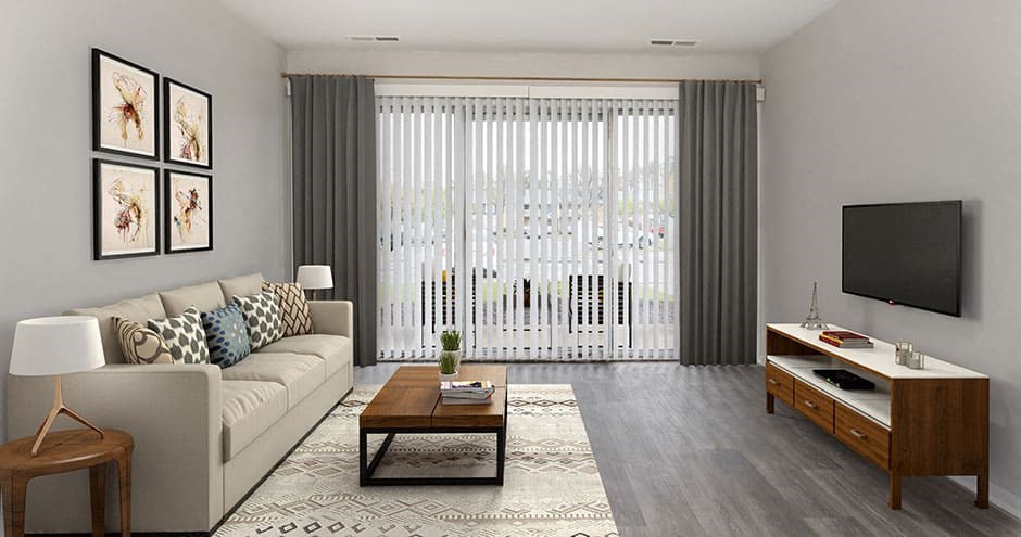apartment living room with couch, area rug and coffee table with sliding door leading out to balcony