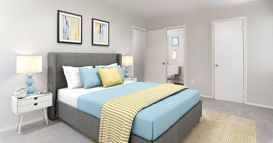 bedroom of the apartment showing queen bed with artwork and attached bathroom