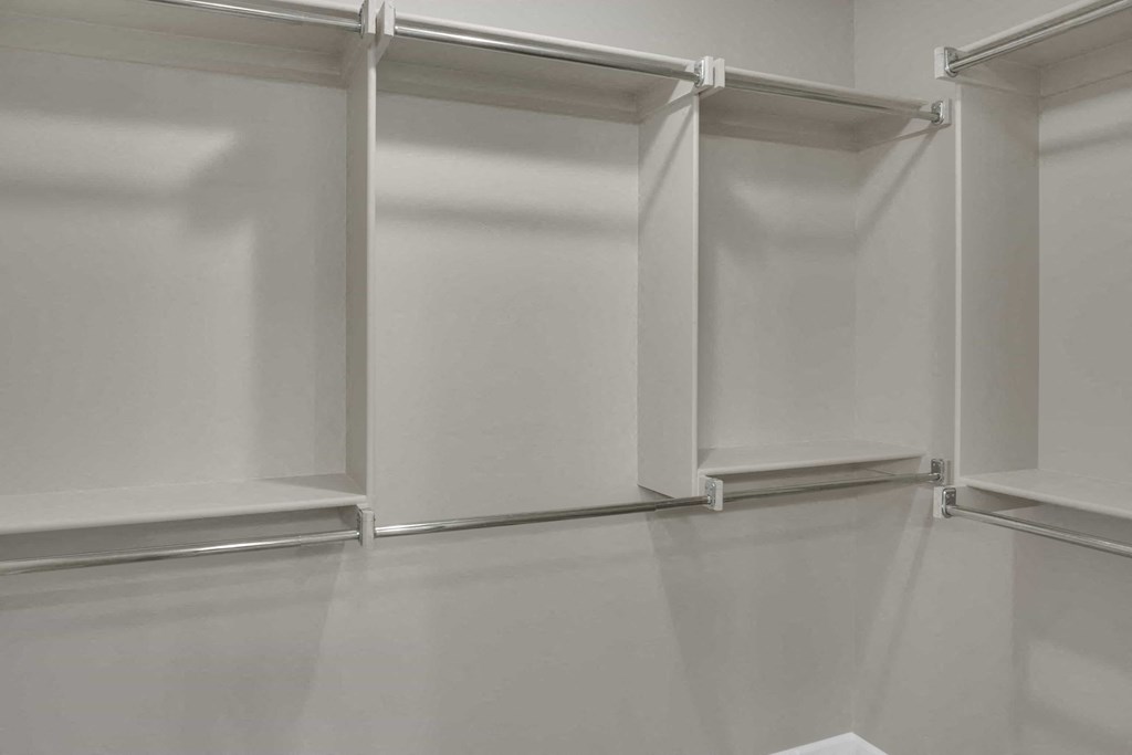 an empty room with white walls and sliding glass doors