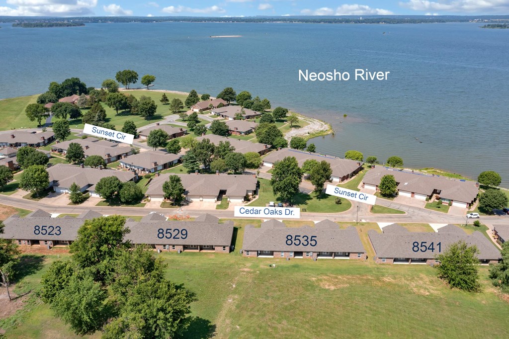 an aerial view of a neighborhood of houses near the water