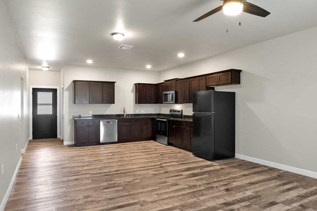 a kitchen with a refrigerator and a sink
