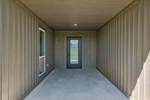 a long hallway with a door at the end of it