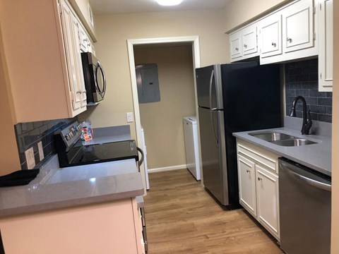 a kitchen with a sink and a refrigerator