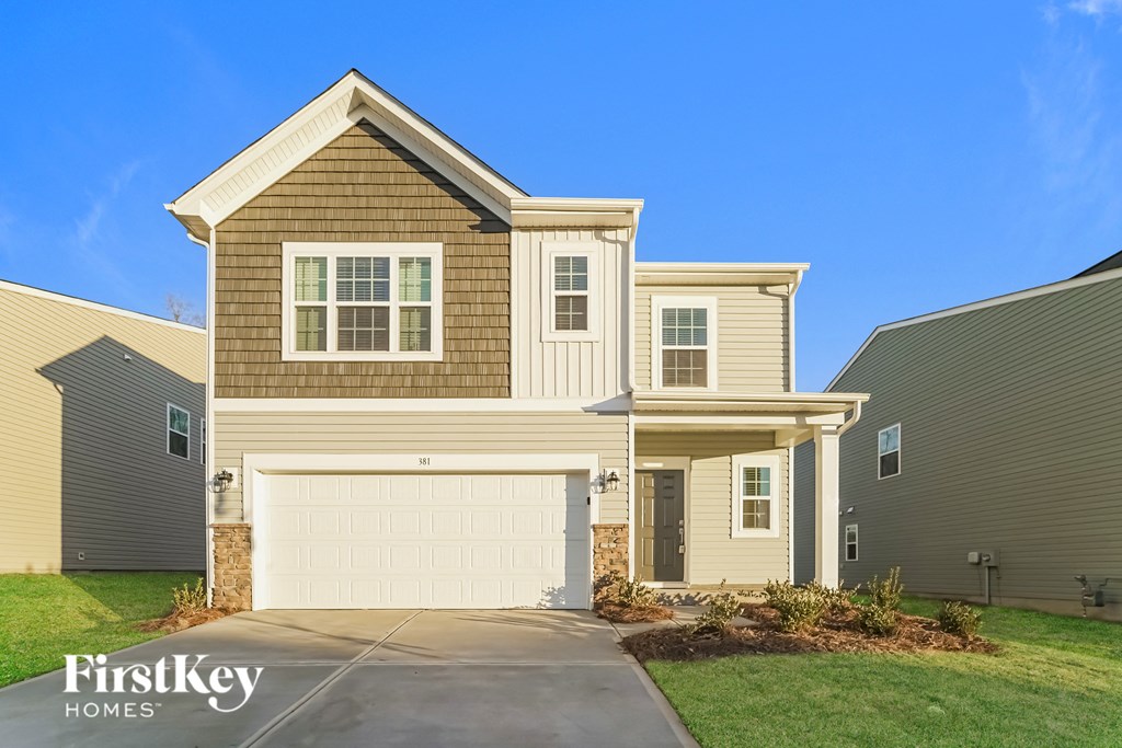 a tan house with a white garage door