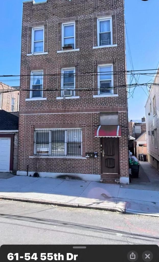 A brick building with the address 61-54 55th Dr displayed on the bottom.