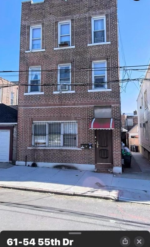 A brick building with the address 61-54 55th Dr displayed on the bottom.