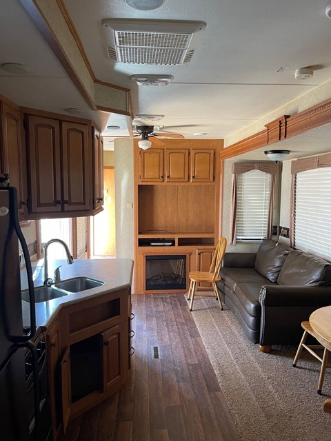 an rv living room with a couch and a kitchen