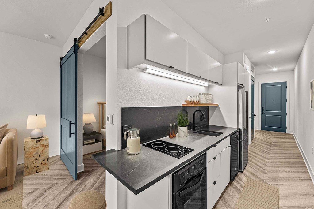 a kitchen with a stove and a refrigerator