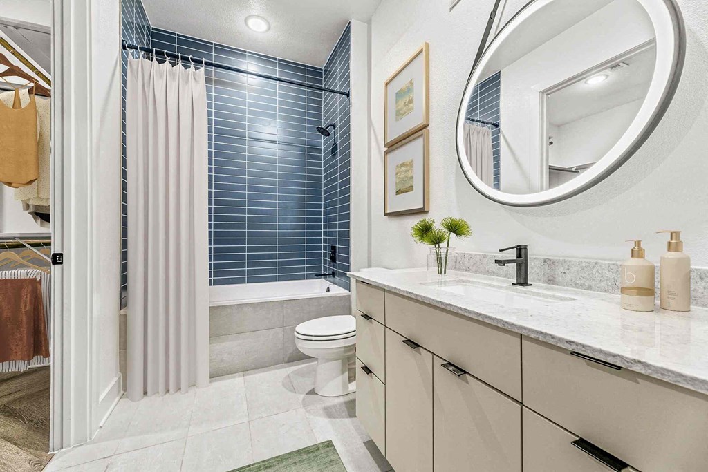 a bathroom with a shower and a sink and a toilet