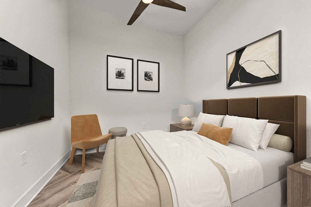 a white bedroom with a large bed and a ceiling fan