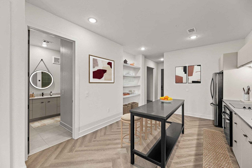 a kitchen and dining room with a sink and a mirror