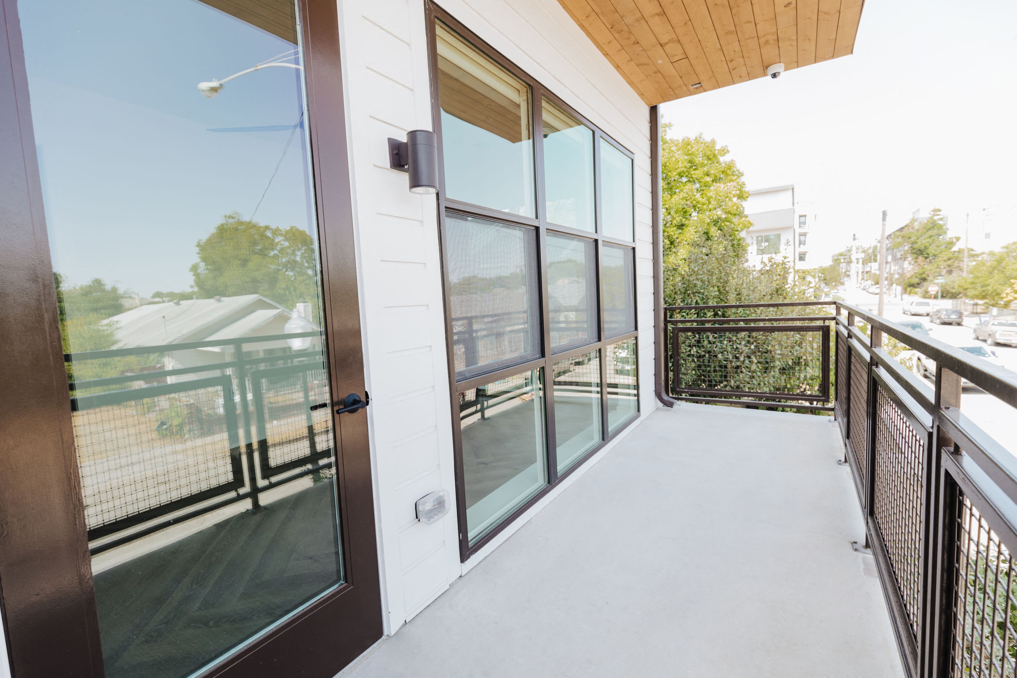a large glass door on a balcony with a view