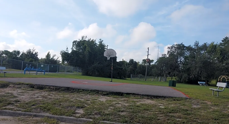 a basketball court in a park