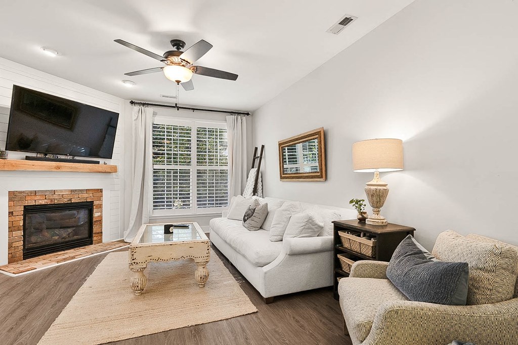 a living room with a couch and a ceiling fan