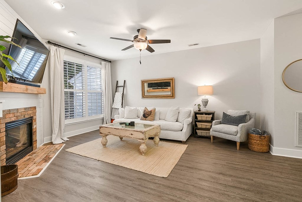 a living room with a couch and a ceiling fan