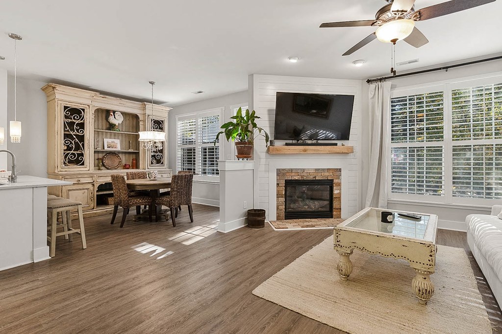 a living room with a fireplace and a table