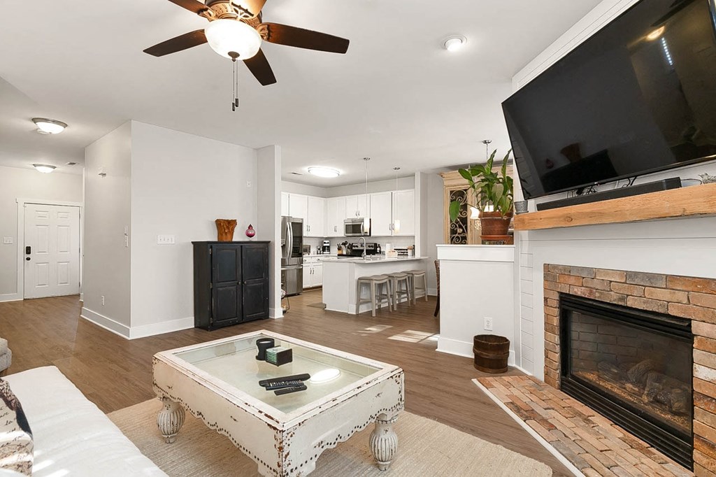 a living room with a fireplace and a television