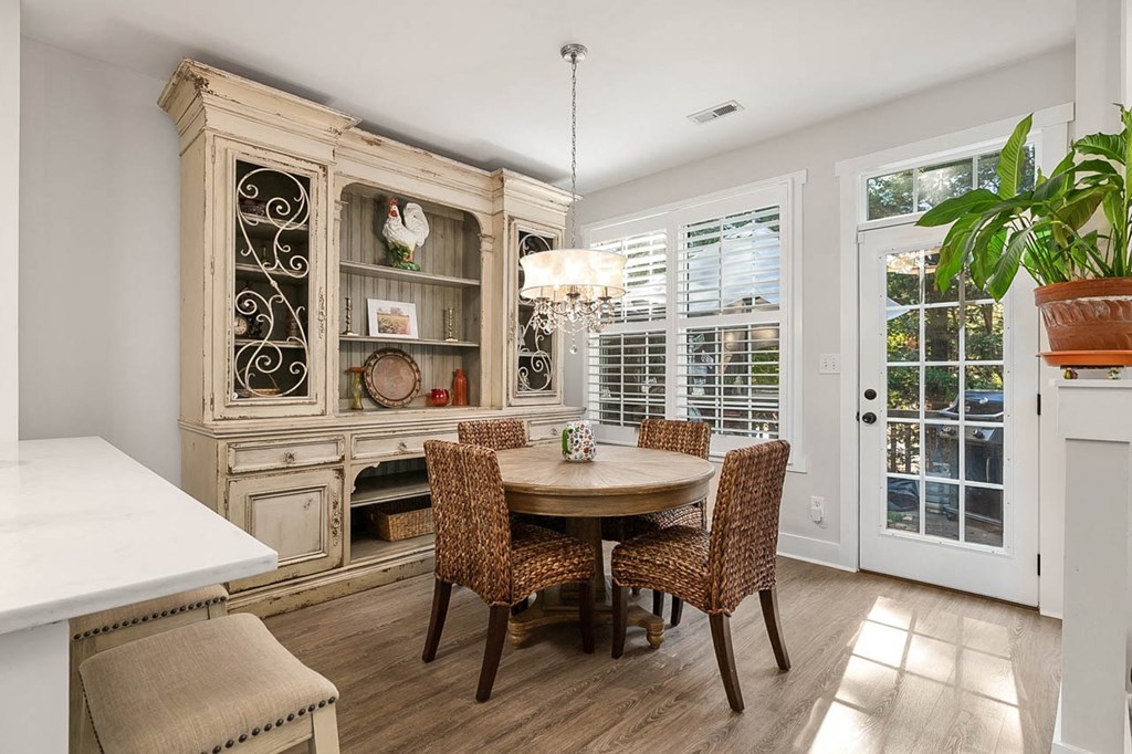a dining room with a table and chairs