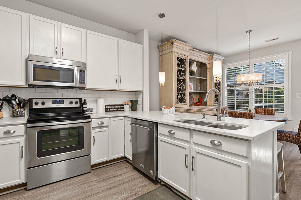 a kitchen with stainless steel appliances and white cabinets