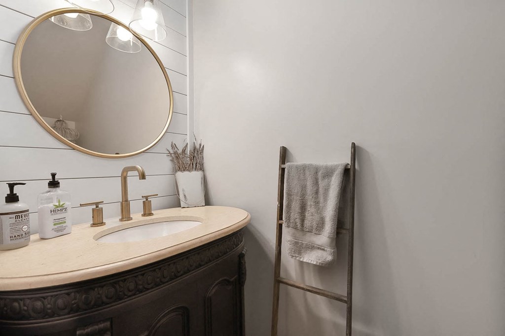 a white bathroom with a sink and a mirror