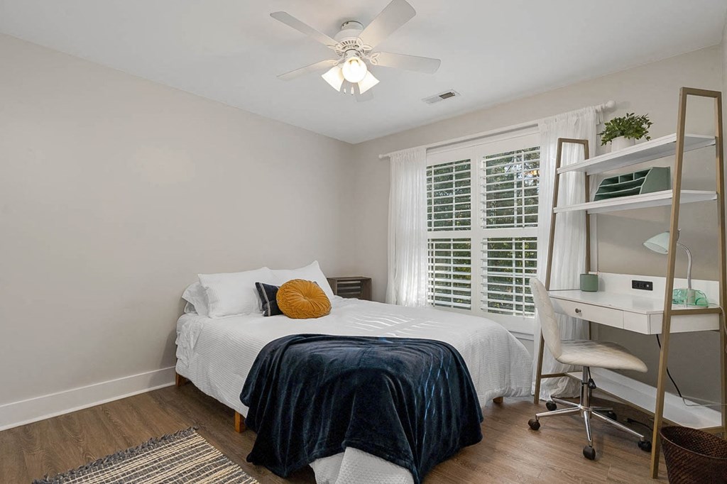a bedroom with a bed and a ceiling fan