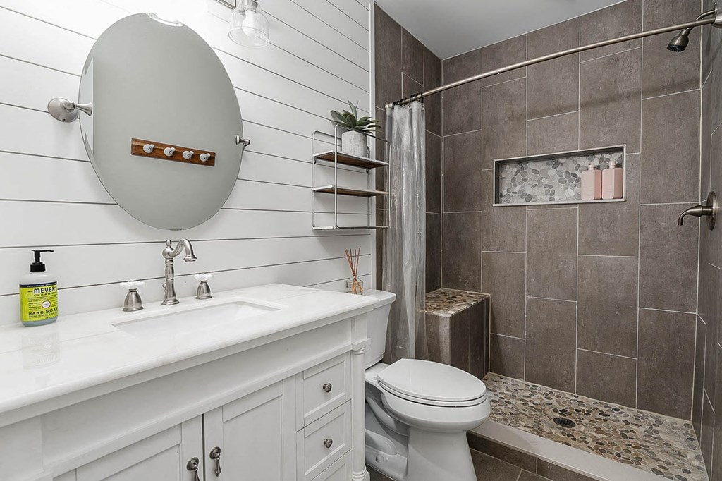 a bathroom with a toilet and a sink and a shower