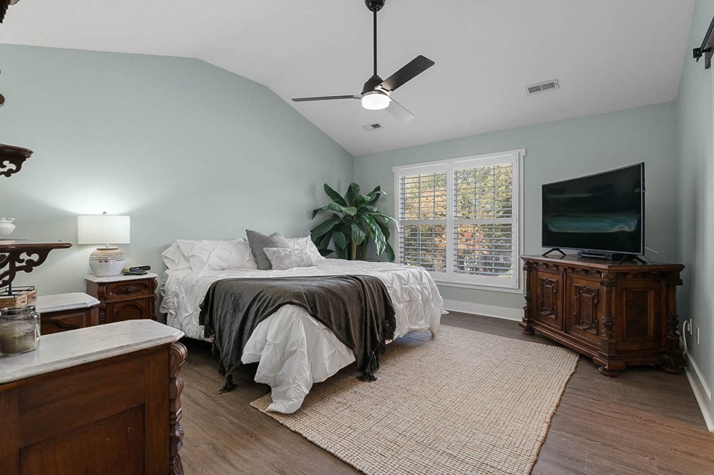 a bedroom with a bed and a tv