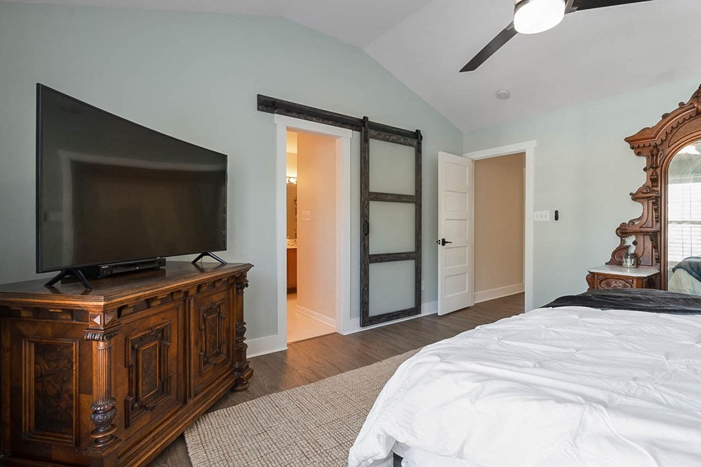 a bedroom with a tv and a bed