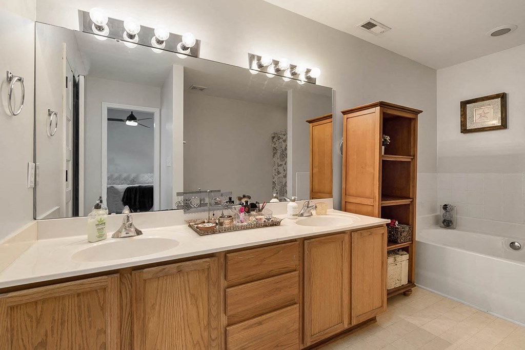 a bathroom with two sinks and a large mirror