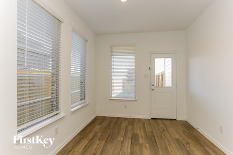a living room with wood floors and a white door