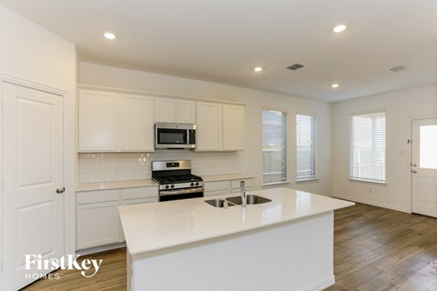 a kitchen with white cabinets and a white counter top