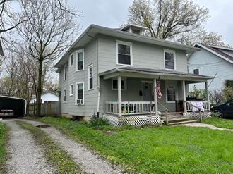 a house with an flag on the porch