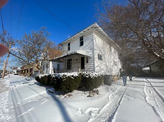 a house on a street covered in snow