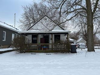 our house in the snow with a tree