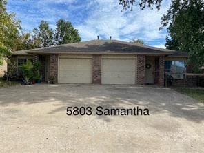 a house with two garage doors and the name 560 samantha