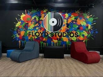 the lobby studios with two chairs and a wall mural