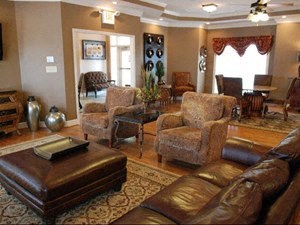 a living room with a leather couch and chairs