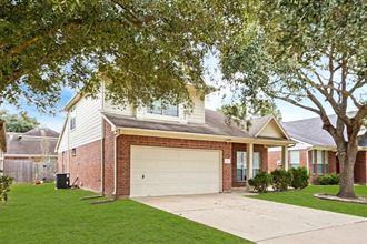 a brick house with a white garage door