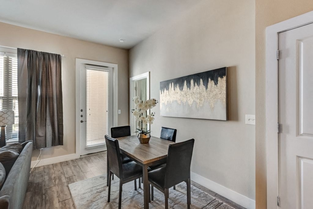 a dining room with a table and chairs and a window