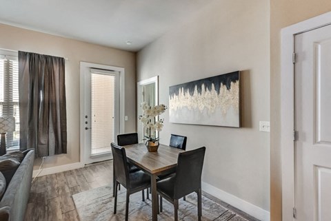 a dining room with a table and chairs and a window