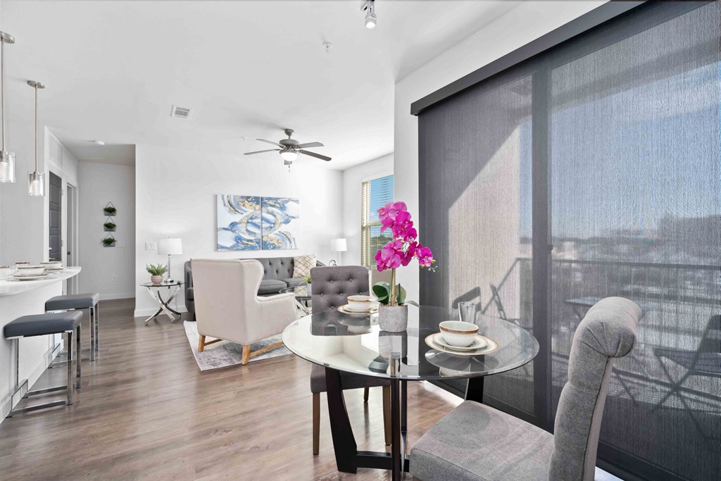 an open living room and dining room with a table and chairs