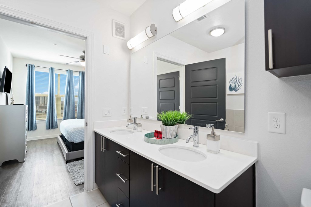 a bathroom with a large mirror and a sink