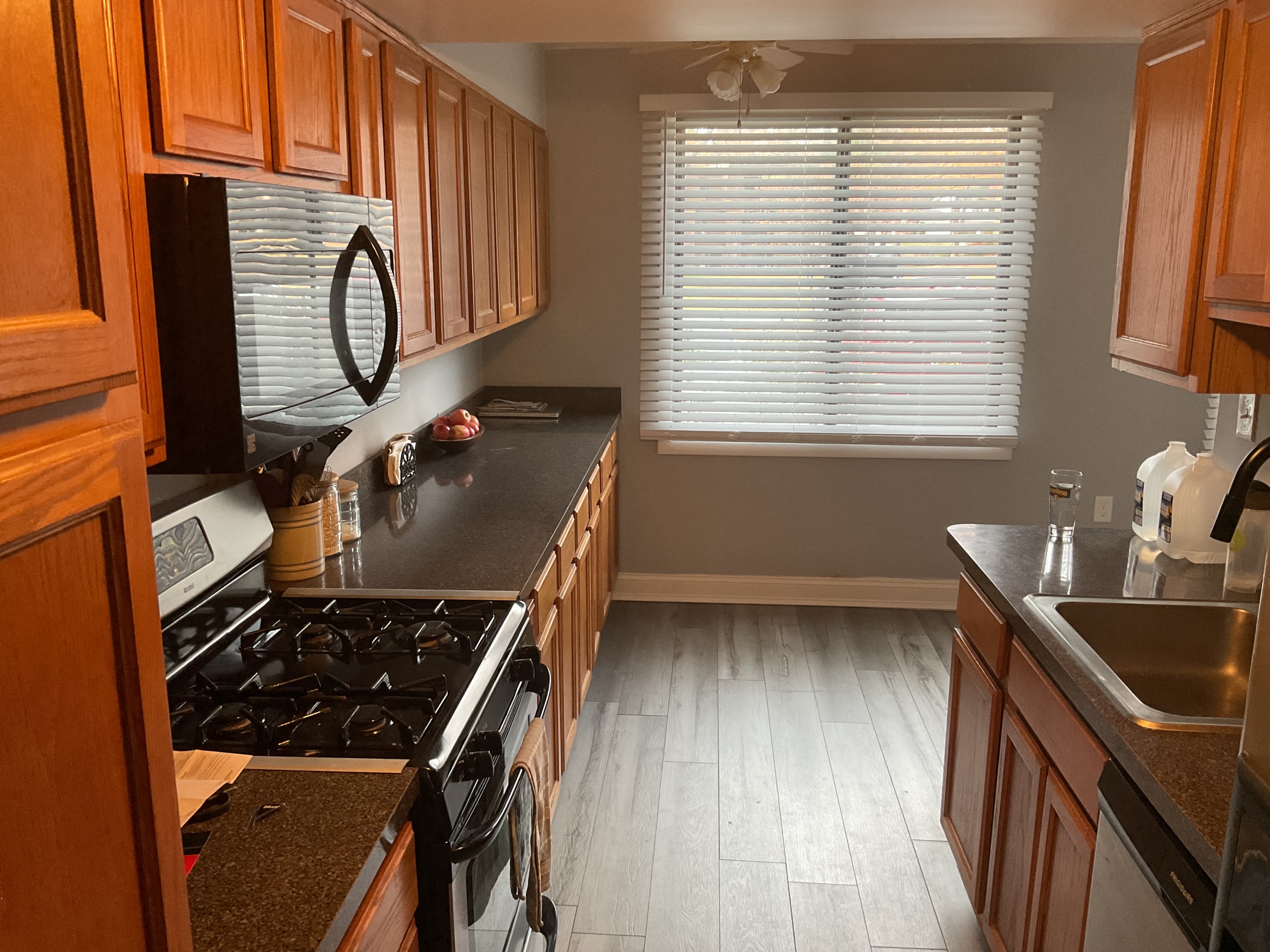 a kitchen with wood cabinets and a stove and a sink